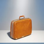 a beat-up hardsided 1960's suitcase