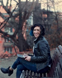 Caroline Topperman sitting outside on park bench