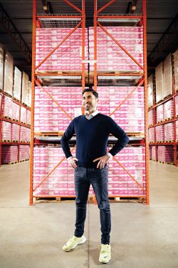 Jay Kleing standing in the Pur warehouse in fron of shelves of product