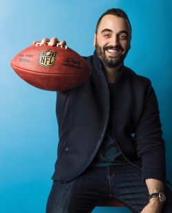 Vincent-Phillip Mirenzi seated, holding out a football