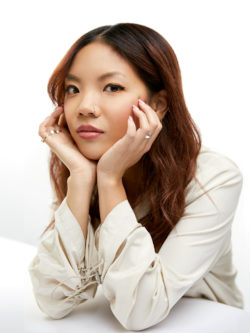 woman with elbows on table, face in hands