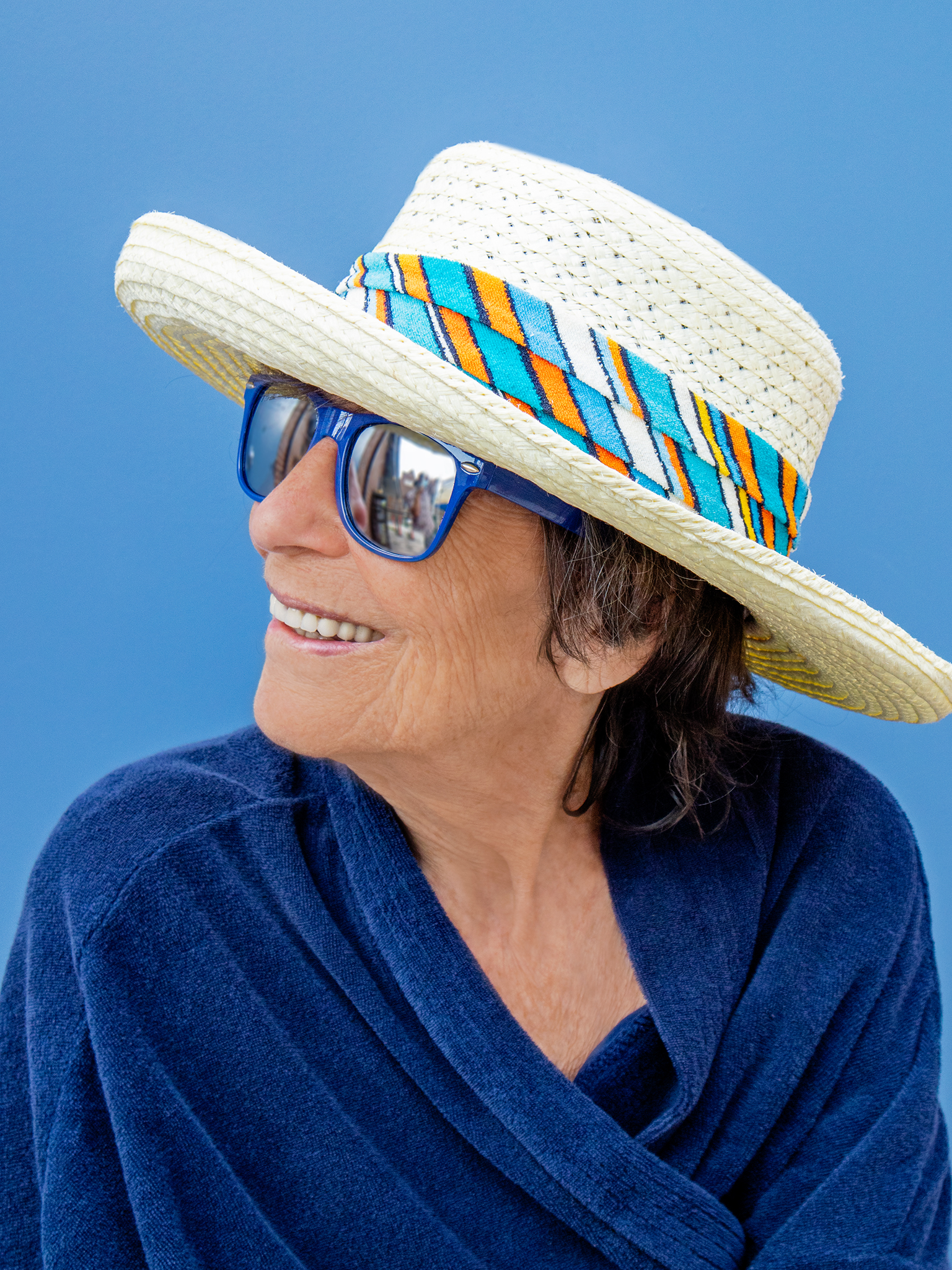 woman in hat and sunglasses smiling