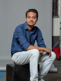 Amit Singh seated on wooden box in photography studio