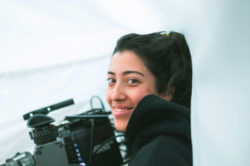 Photograph of Gabriela Osio Vanden holding movie camera