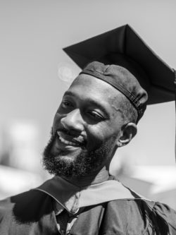 smiling male grad in cap and gown