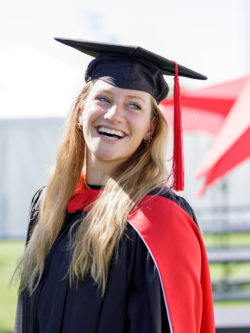 smiling woman grad in cap and gown