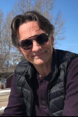 Paul Muir, smiling, wearing sunglasses, outdoors