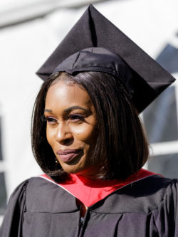 smiling woman grad in cap and gown