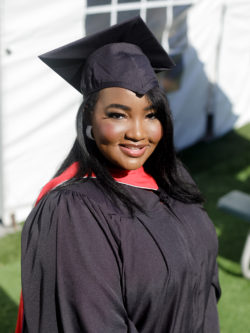 smiling woman grad in cap and gown