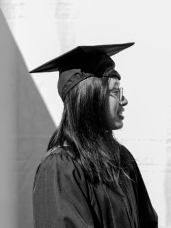 smiling woman grad in cap and gown