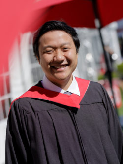 smiling male grad in cap and gown