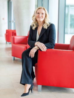 Rhonda Lenton seated in red armchair