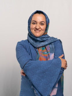 portrait of Laleh Seyyed Kalantari, smiling and arms folded, in front of white background