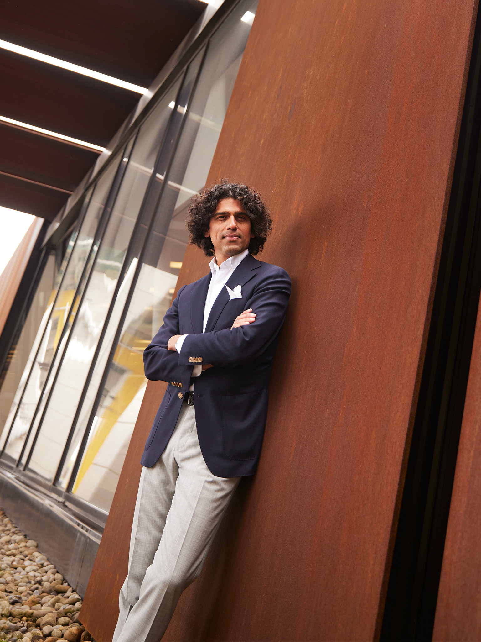 Usman Khan leans against wall at Toronto's Bentway under the Gardener Expressway